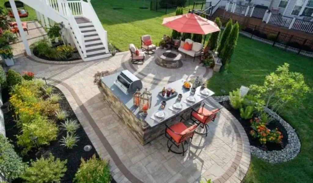 A backyard with diverse landscaping ideas and elegant landscape design, featuring a patio, dining area, and garden.