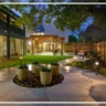 Outdoor landscape lighting illuminating a modern backyard patio with pathway lights, showcasing a professionally designed outdoor space in Naperville, IL.