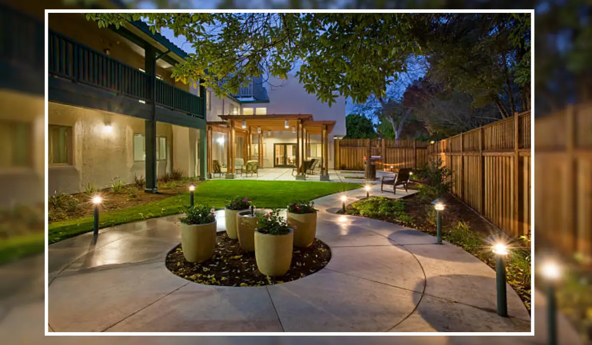 Outdoor landscape lighting illuminating a modern backyard patio with pathway lights, showcasing a professionally designed outdoor space in Naperville, IL.