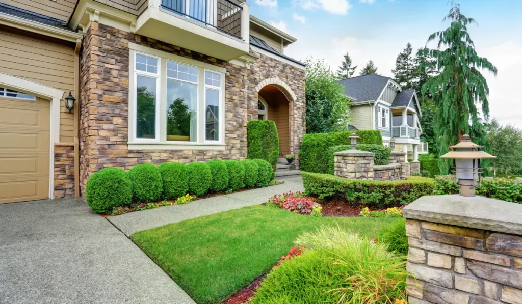 Beautiful front yard eco-friendly landscaping in Lisle, IL, with well-maintained shrubs and a stone pathway for a low-maintenance outdoor space.