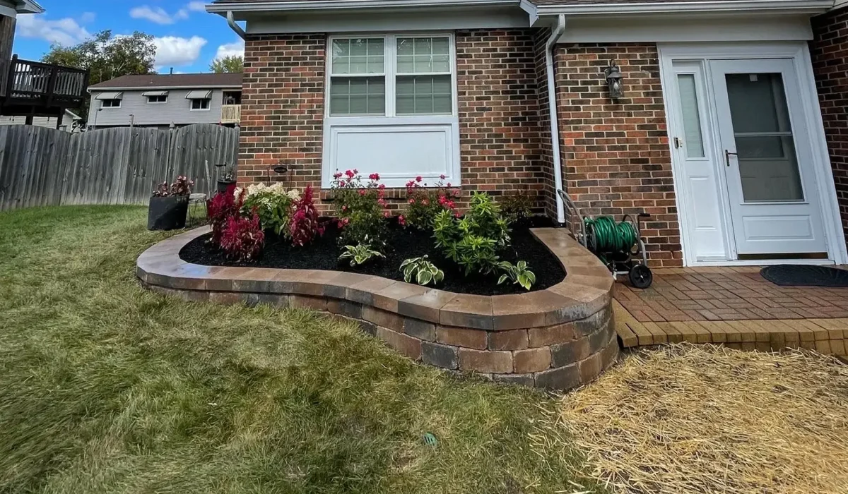 a vibrant front yard landscape in full spring bloom, featuring a lush lawn and a variety of flowering plants